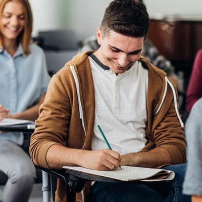 joven escribiendo en un pupitre